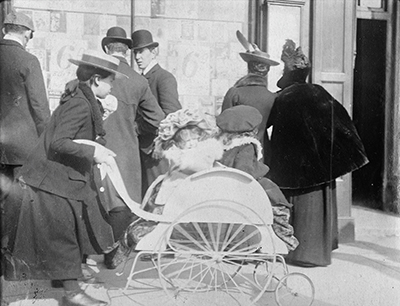 Young girl pushing 2 infants in a perambulator 1904